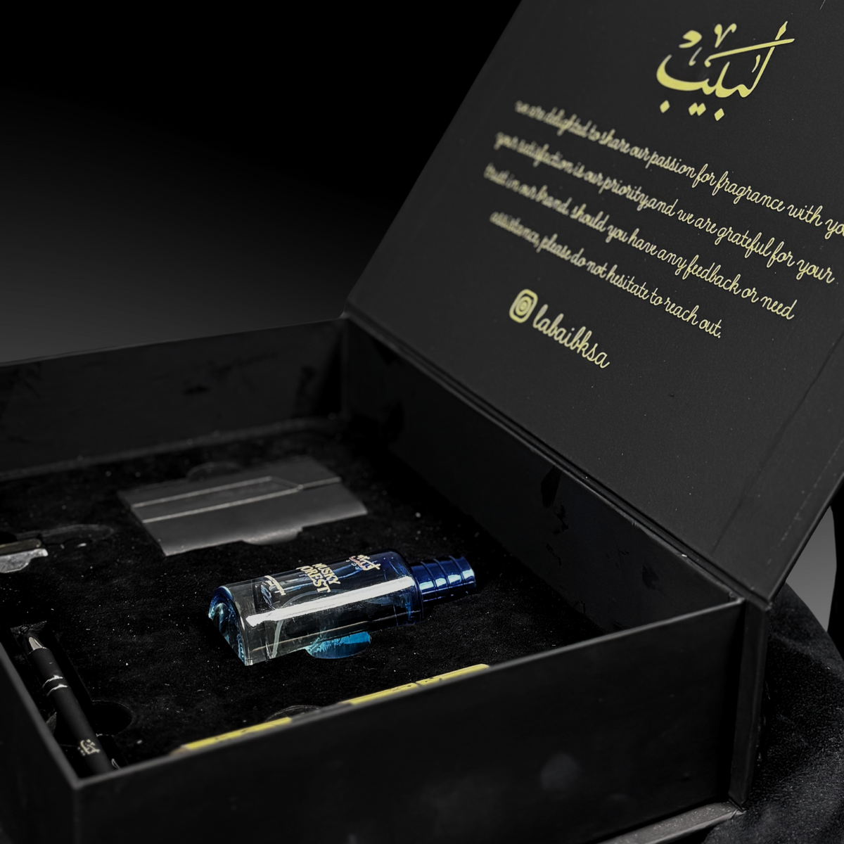 Labaib Premium Box featuring signature perfume, rich attar, body mist, leather card holder, and premium pen elegantly arranged for luxury gifting.